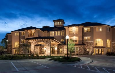 Exterior view of a senior living facility at dusk