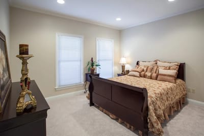 Cozy bedroom with a floral comforter and soft lighting