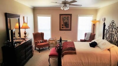 A spacious bedroom with comfortable furnishings