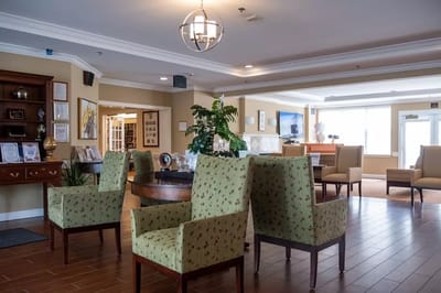 Interior of a common area with green chairs and decor