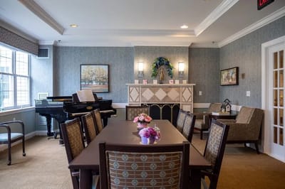 Common area with dining table and piano in the background