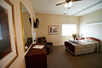 Well-furnished private resident room with a bed and chair