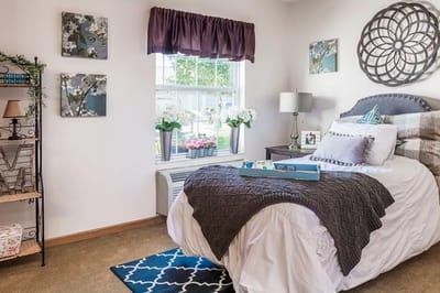 Cozy resident room with decor and bedding