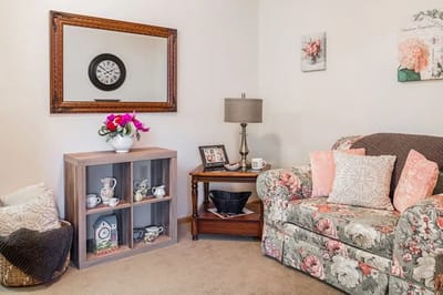 Cozy sitting area with floral couch and decor