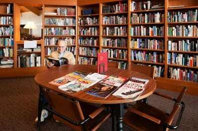 Resident reading in a well-stocked library