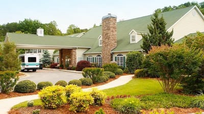Exterior view of Brasstown Manor Senior Living building and garden.