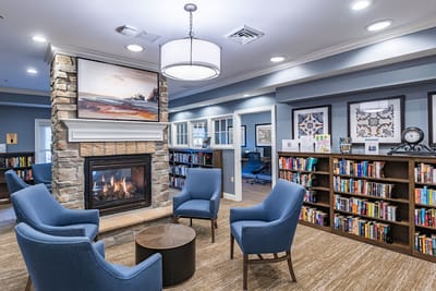 Cozy common area with bookshelves and a fireplace