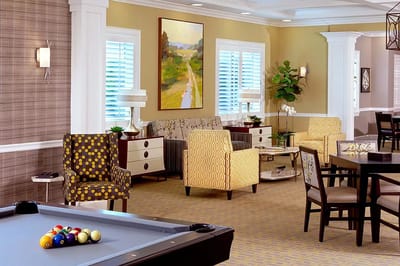 Bright common area with seating and a pool table