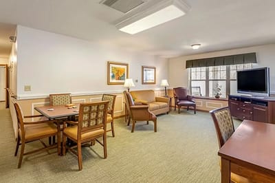 Bright common area with comfortable seating and tables