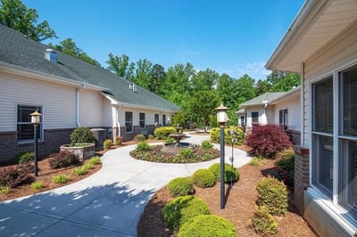 Well-maintained garden area with walking paths and landscaping