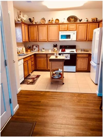 Bright kitchen area with wooden cabinets and appliances