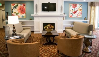 Interior lounge area with comfortable seating and floral art