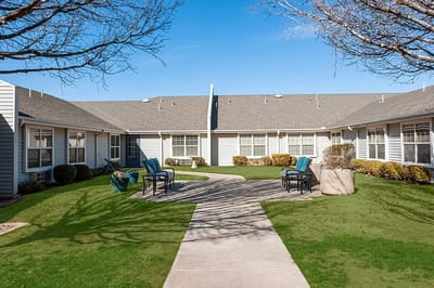 Outdoor area with seating and paths in a senior living facility