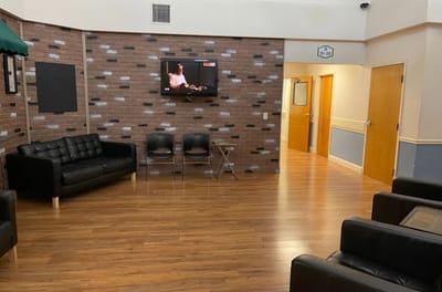 Interior common area with seating and a TV