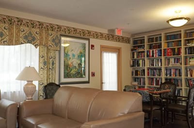 Cozy common area with bookshelves and comfortable seating