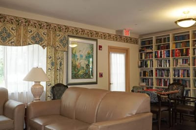 Cozy common area with seating and bookshelves