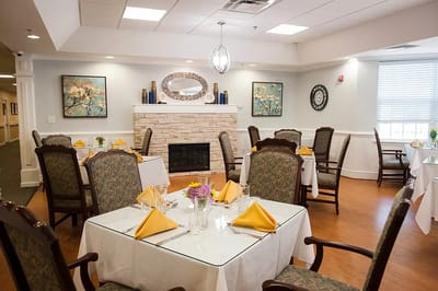Bright dining room with neatly set tables and decorations