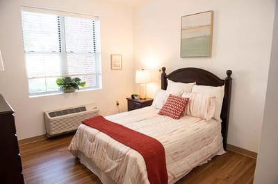 A cozy resident room with a bed and window