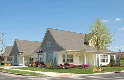 Exterior view of a senior living facility with landscaping