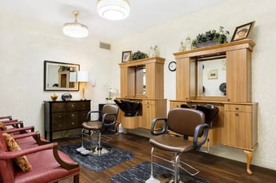 Hair salon area with styling chairs and mirrors