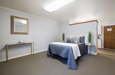 A neatly arranged bedroom in a senior living facility