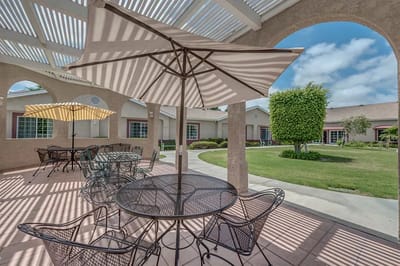 Outdoor seating area with umbrellas and greenery