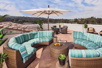 A sunny outdoor lounge area with comfortable seating