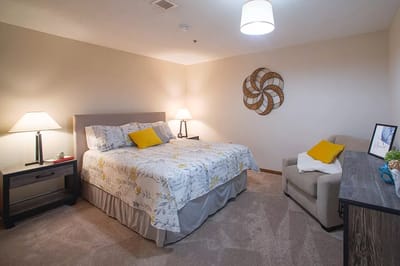 Cozy interior of a resident's private room with a bed