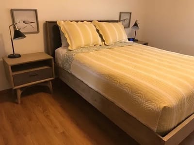 Cozy private bedroom with a bed and bedside tables