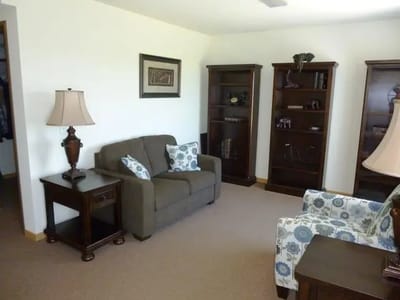 A cozy common area with seating and shelves