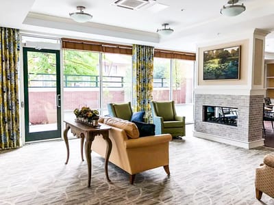 Bright common area with seating and fireplace