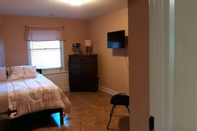 Private resident room with a bed and TV