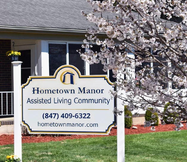 Sign for Hometown Manor Assisted Living Community outside a building