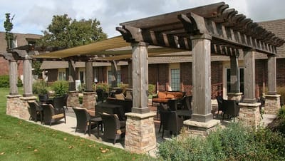 Outdoor seating area with a pergola and garden