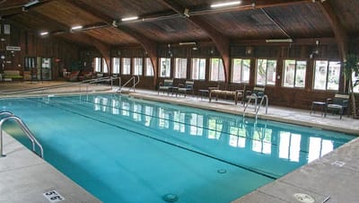 Indoor swimming pool area with lounge chairs