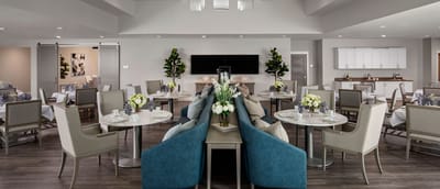 Bright dining room with tables and floral centerpieces
