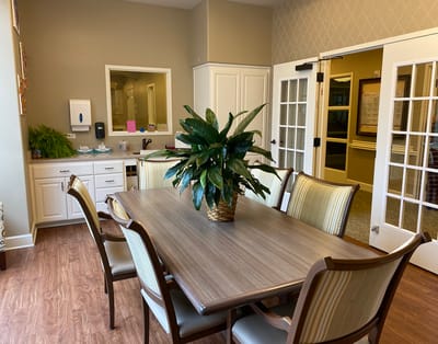 Bright common area with a large table and plants