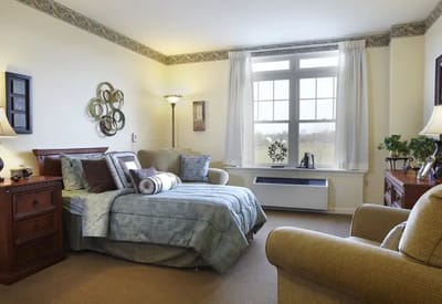 Cozy resident room with a bed and seating area
