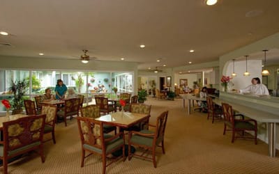 Bright dining area with residents and staff