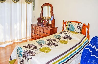 Cozy bedroom with a single bed and dresser