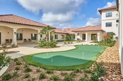 Outdoor courtyard with putting green and patio areas