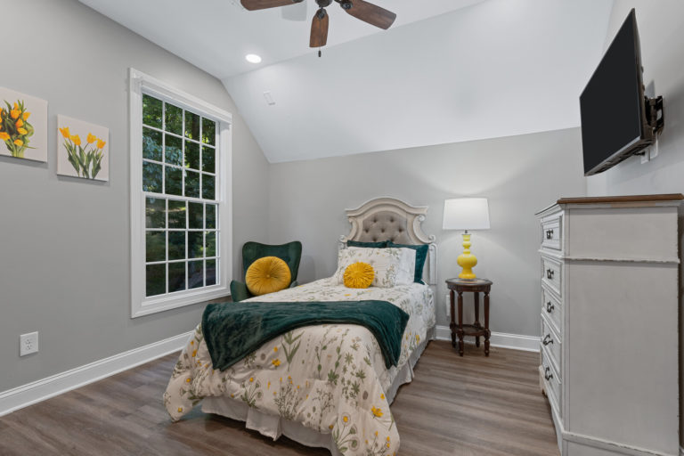 Cozy private room with yellow accents and floral bedding
