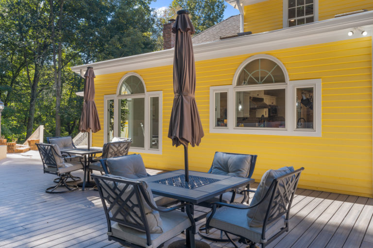 Outdoor seating area with umbrellas and view of building