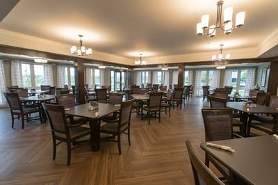 Dining room with tables and chairs in an interior setting