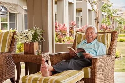 A resident reading on a patio at the facility