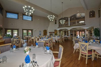 Bright dining room with tables set for a meal
