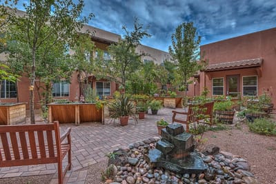 A serene outdoor courtyard with plants and seating