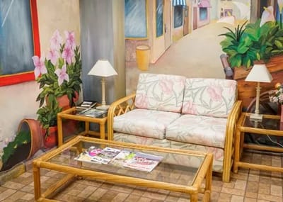 Cozy lounge area with a floral mural backdrop