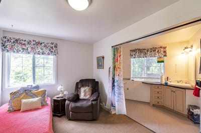 Cozy resident room with comfortable seating and personal touches