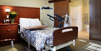 Private resident room with medical equipment and flowers